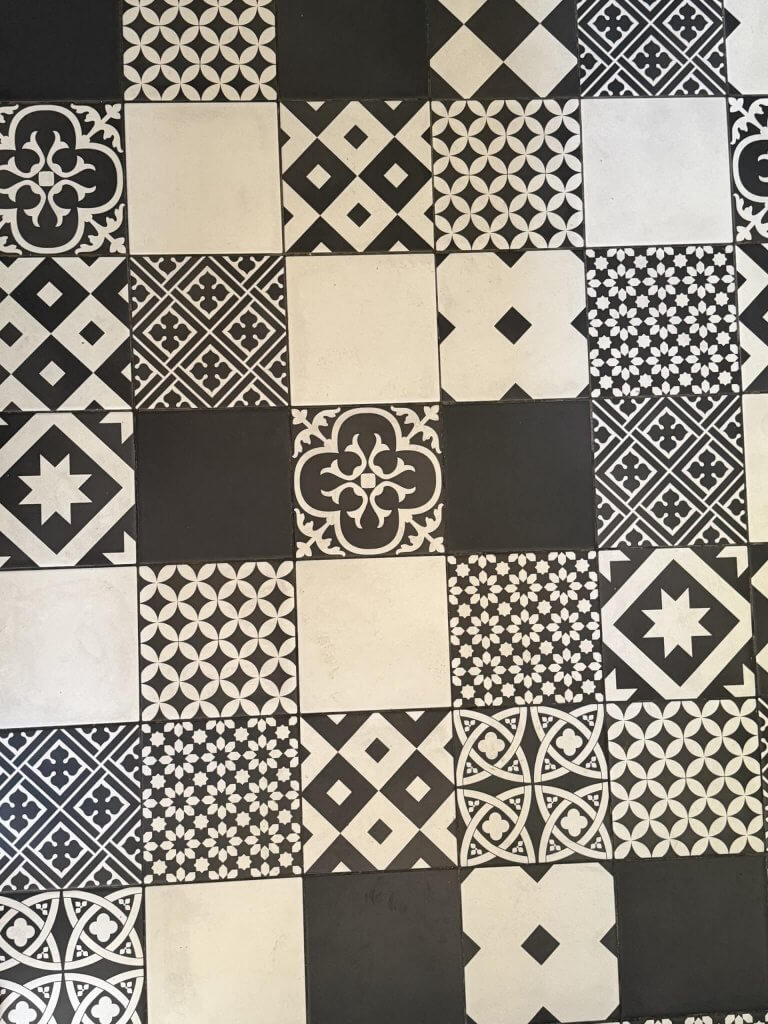 Schwarz-weißer Fliesenboden mit verschiedenen geometrischen Mustern – Quiltinspiration im Urlaub