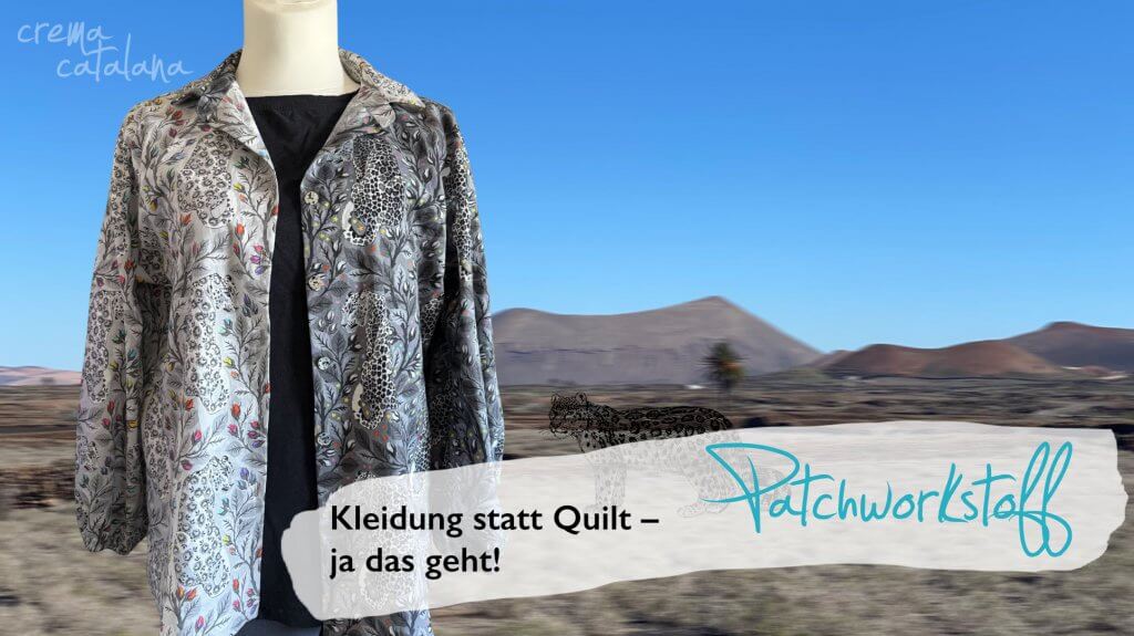 Alea-Bluse aus Tula Pink Graywork offen über schwarzem Top getragen, Vulkanlandschaft im Hintergrund, Text: Kleidung statt Quilt – ja das geht!